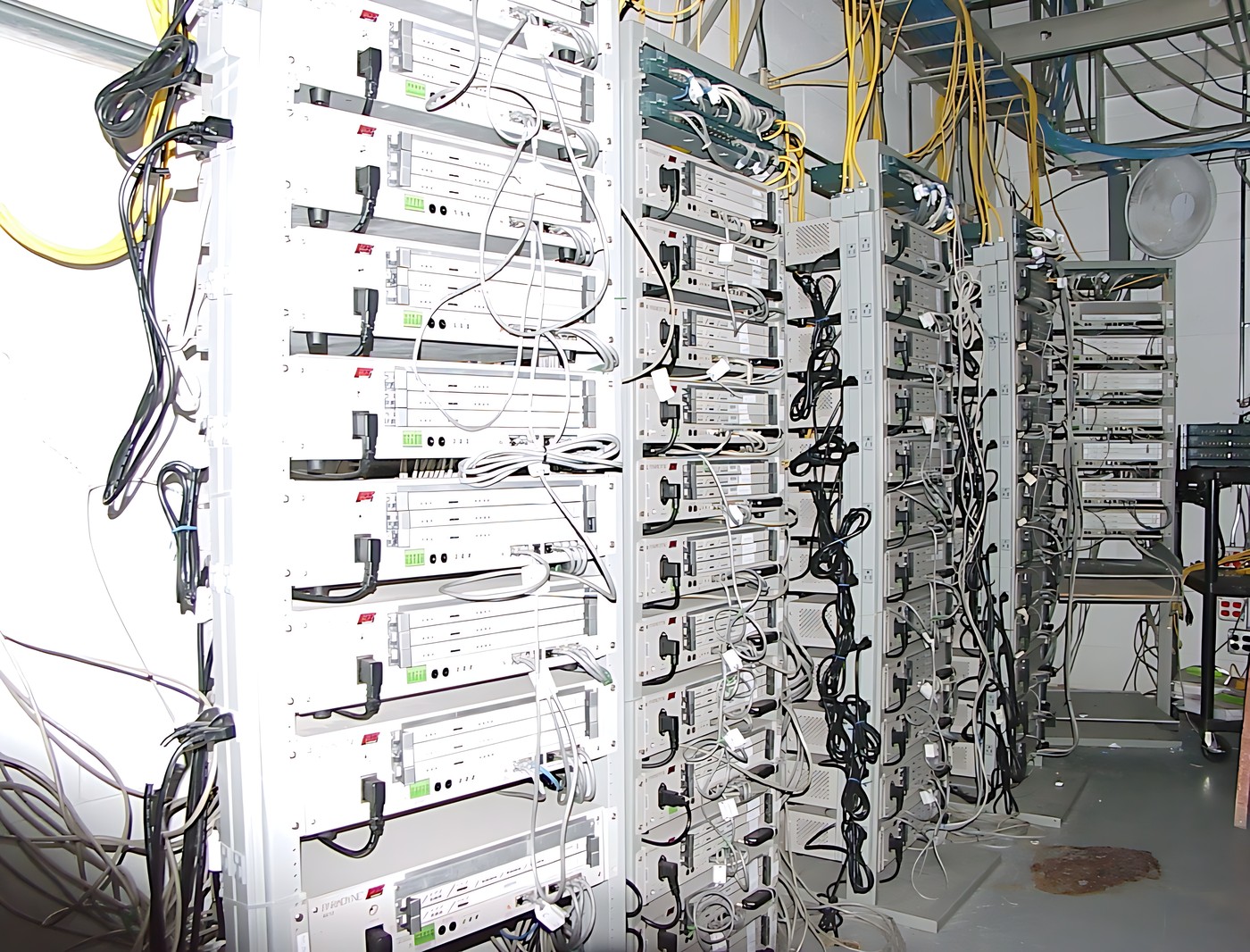 Large room with multiple rows of electrical equipment
